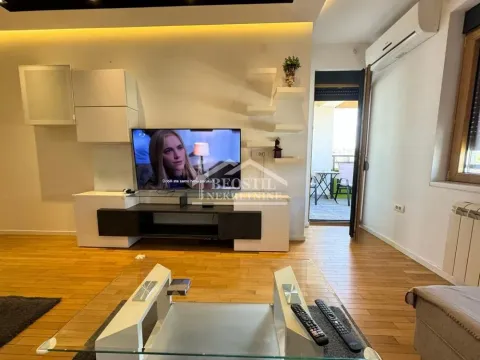 Living room with a TV, furniture, and access to the terrace. - image 15