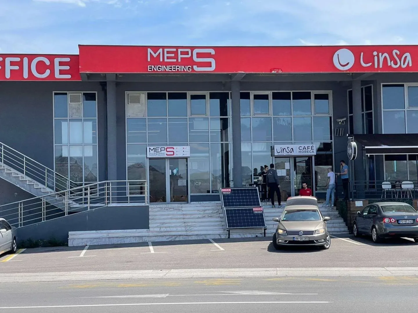 Exterior view of a commercial building with parking space in front of the entrance.