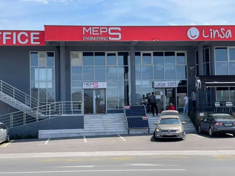 Exterior view of a commercial building with parking space in front of the entrance. - image 4
