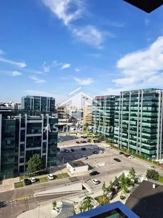 View from the balcony overlooking the urban neighborhood and office buildings.