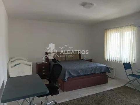 Spacious bedroom with a double bed, desk, and a cot. - image 8