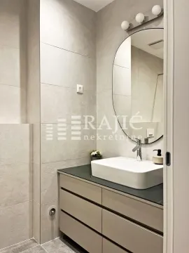 Modern bathroom equipped with a washbasin and mirror. - image 7