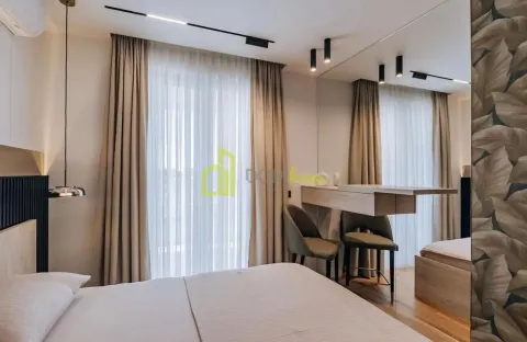 Modern bedroom with a double bed, a desk, and a large window with curtains. - image 11