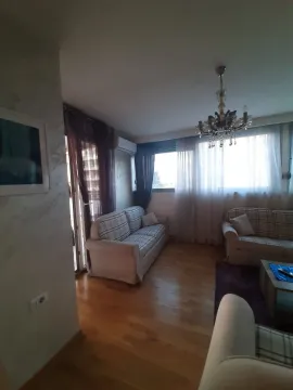 Bright living room with a sofa set and a chandelier. - image 3