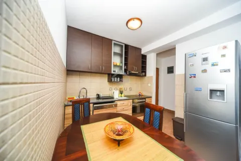 Kitchen with a dining table and wooden cabinets. - image 5