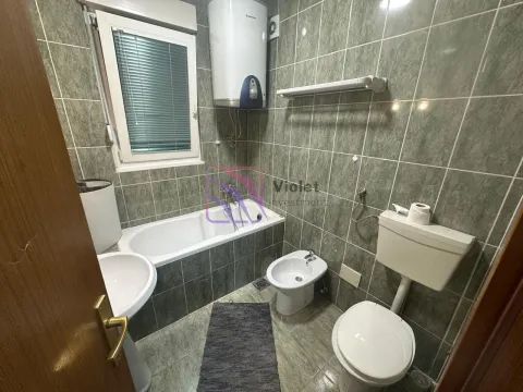 Smaller tiled bathroom with a bathtub, toilet, and bidet. - image 9