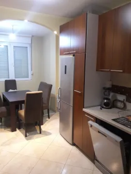 A functional kitchen with a dining area and built-in appliances. - image 6