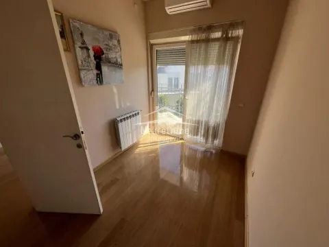 Empty room with wooden flooring and access to a terrace. - image 11