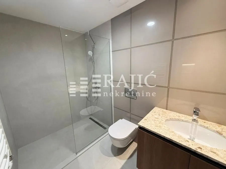 Modernly equipped bathroom with a walk-in shower.