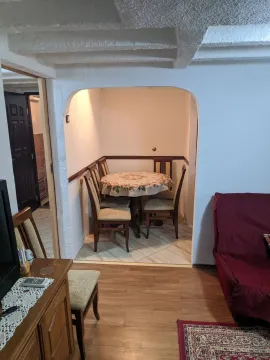 Living room with a dining table in an alcove. - image 2