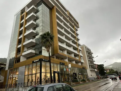 Exterior view of a modern multi-story residential building with commercial spaces on the ground floor. - image 2