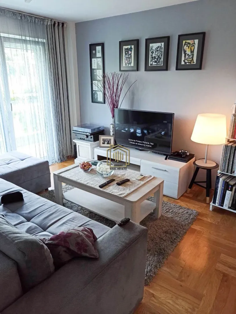 Living room with a corner sofa, television, and coffee table.
