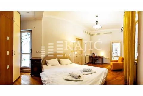 Spacious bedroom with a double bed, wardrobe, and a desk. - image 13