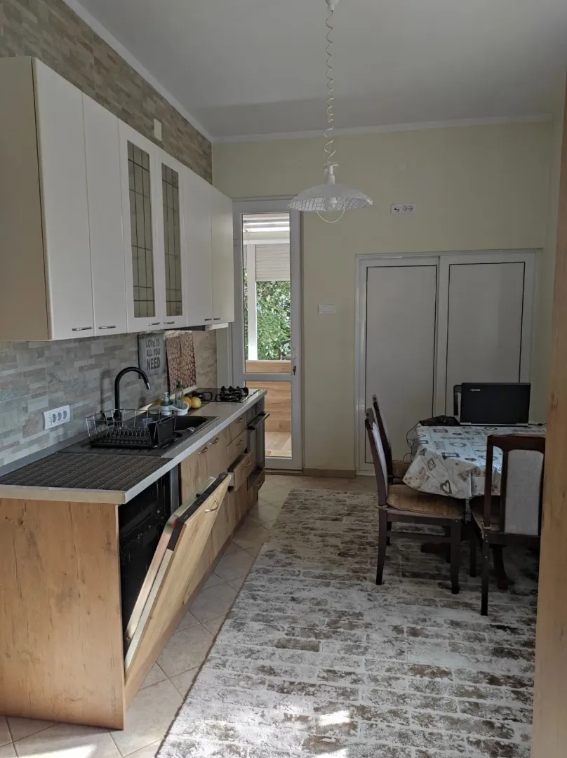 Bright kitchen with wooden elements and a dining table.