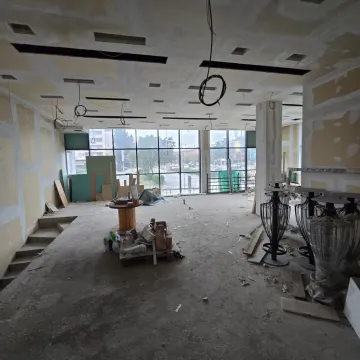 Large space under renovation with large windows and a dropped ceiling. - image 4