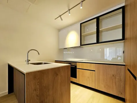 Modern kitchen with a counter and built-in appliances. - image 9