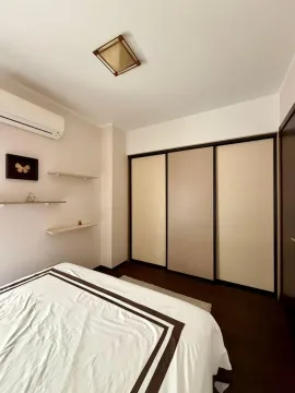 Tidy bedroom with a double bed, built-in wardrobe, and air conditioning. - image 14