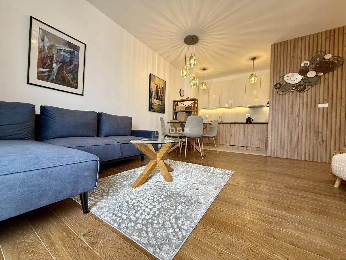 Living room with a sofa set and a dining area in the background.