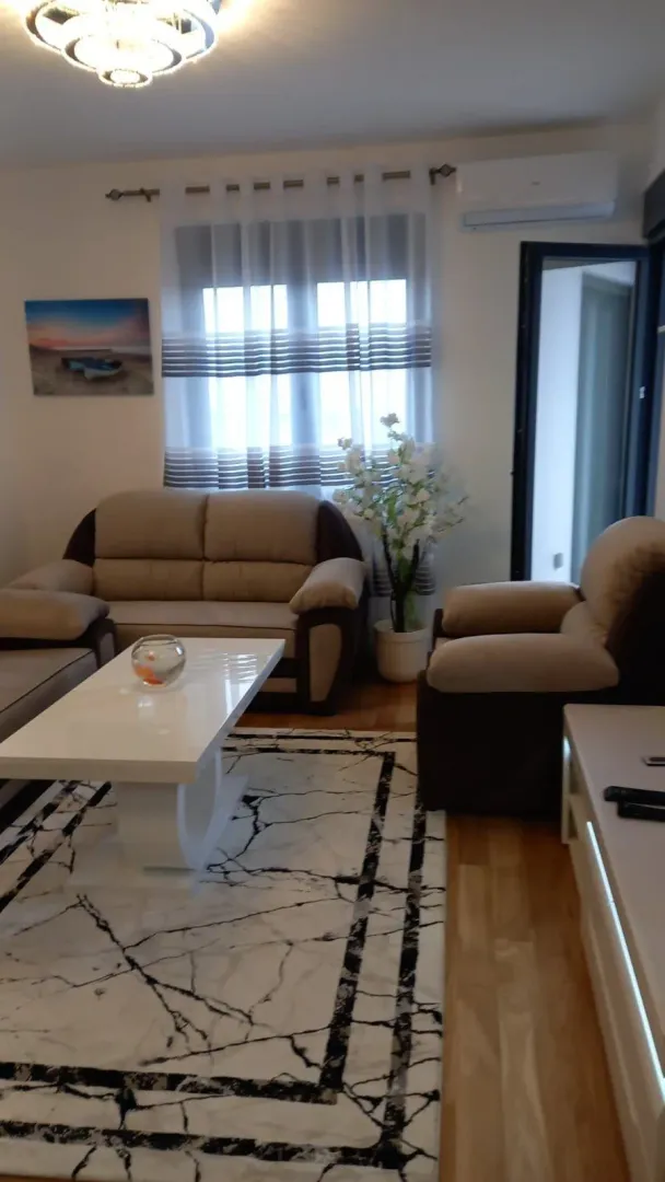 Bright living room with comfortable furniture and a white coffee table.