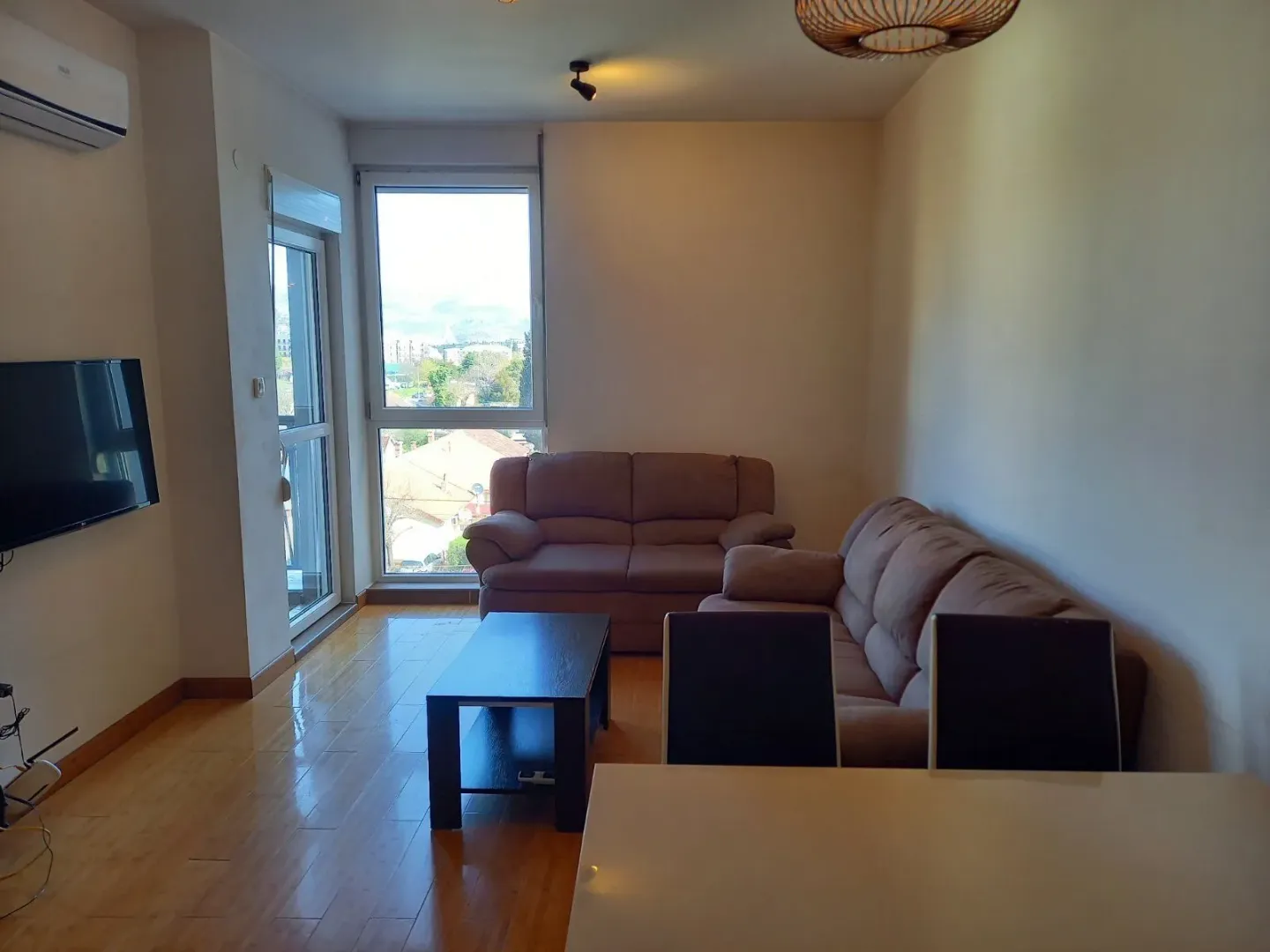 Bright living room with leather sofas and a coffee table.