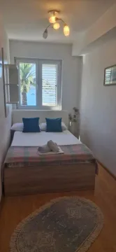 Furnished bedroom with a double bed and a sea view. - image 9