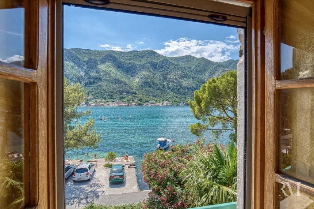 Sea and mountain view through a window.
