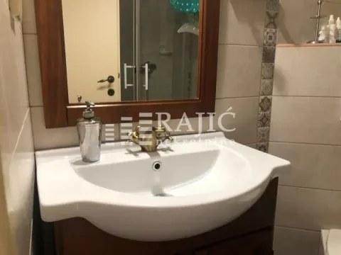 Bathroom with a sink, cabinet, and mirror. - image 8