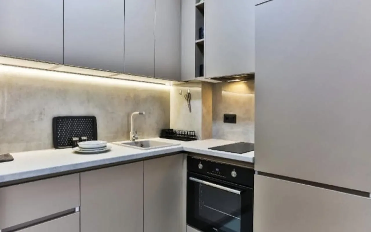 Modern kitchen with built-in units and a sink.