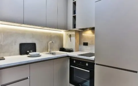 Modern kitchen with built-in units and a sink. - image 11