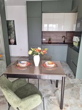 Dining table with chairs in front of a modern kitchen. - image 5