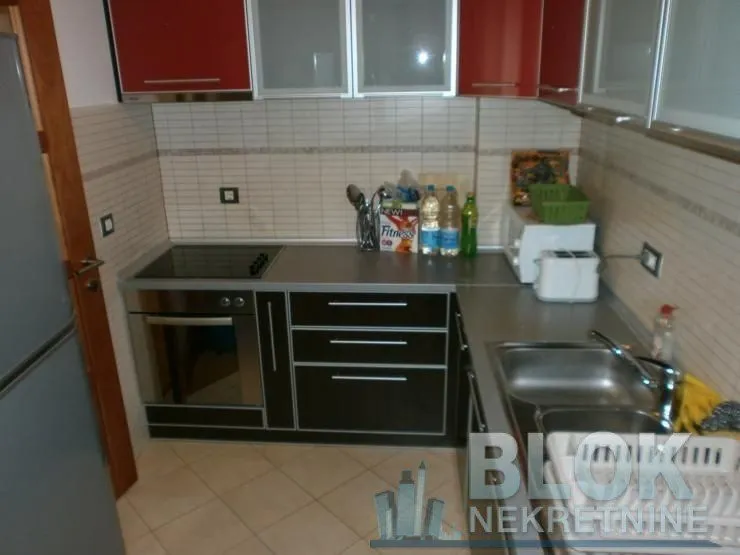 Smaller kitchen with cabinetry and sink.