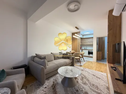 Living room with a sofa and dining area in an open space layout. - image 2