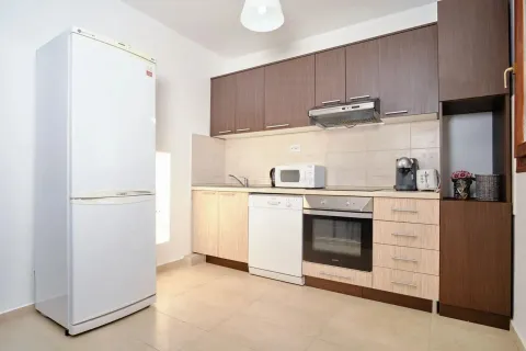 Modern kitchen with built-in cabinetry and white goods. - image 8
