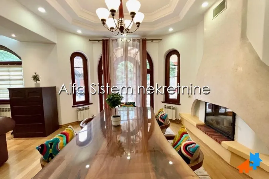 Spacious living room with a large dining table and fireplace.
