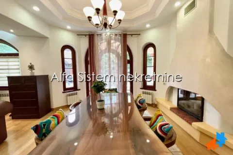 Spacious living room with a large dining table and fireplace. - image 10