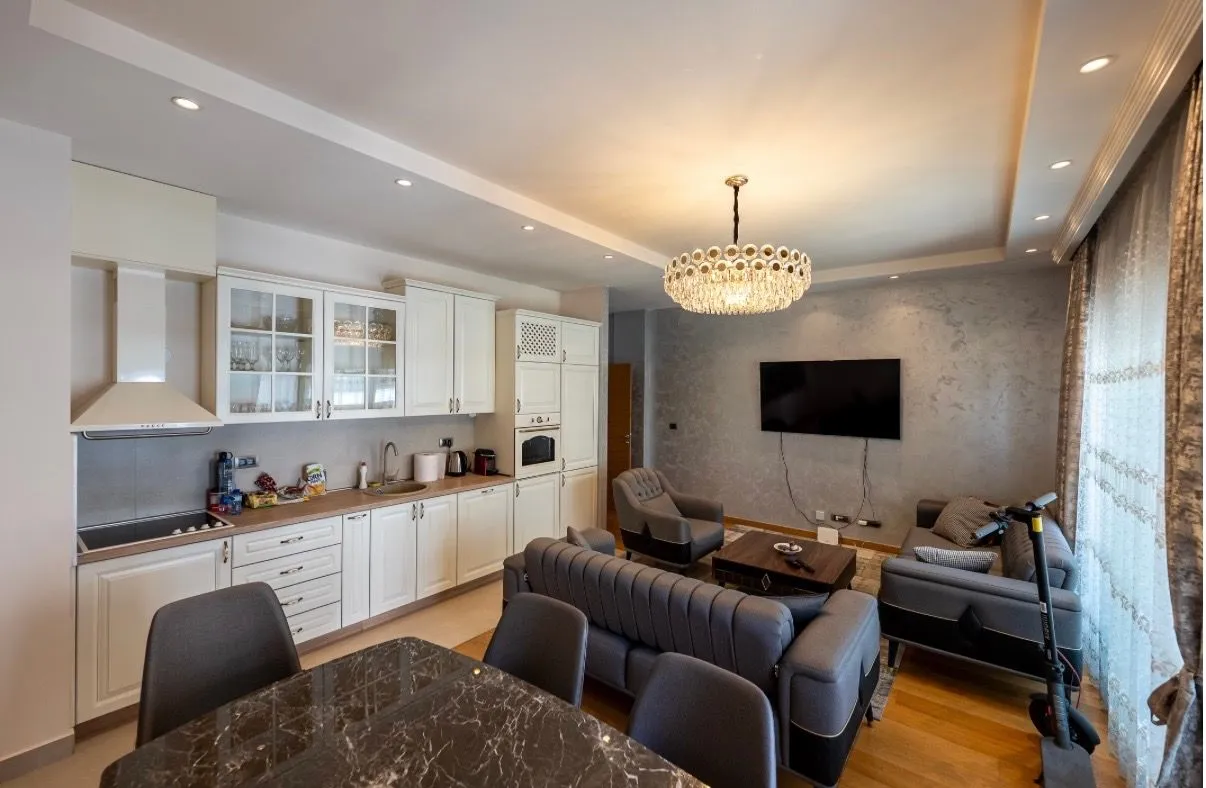 Modern open-plan living room with dining area and kitchen.