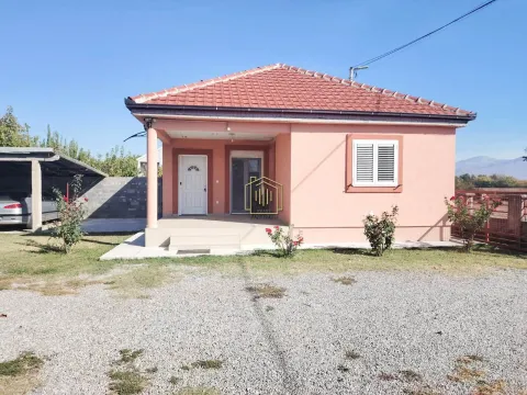 View of the front facade of the house with a landscaped yard and covered parking. - image 10
