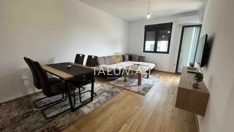 Living room with a sofa set, dining table, and TV cabinet. - image 2