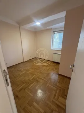 Empty room with hardwood flooring and a window viewed from the entrance. - image 7