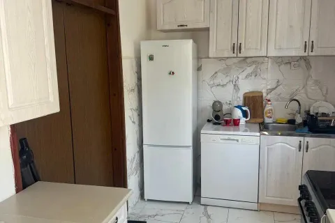 Small kitchen with white cabinets, refrigerator, and sink. - image 9