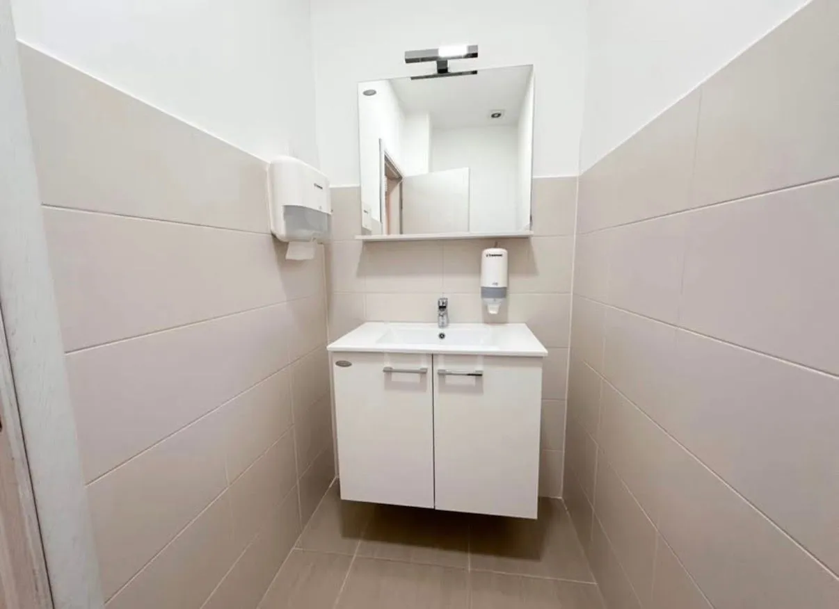 Small bathroom with a vanity, cabinet, and mirror.