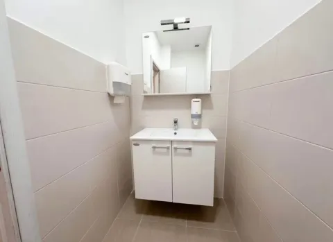 Small bathroom with a vanity, cabinet, and mirror. - image 9