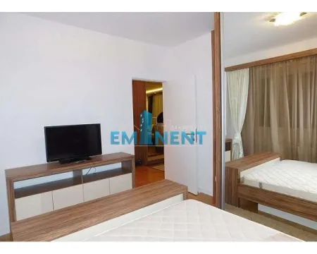 Furnished bedroom with a double bed, TV console, and a large mirrored wardrobe. - image 5