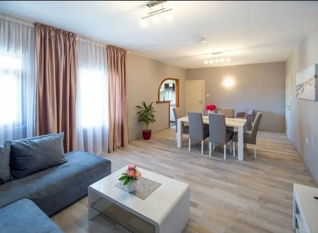Spacious living room with a sofa set and dining table.