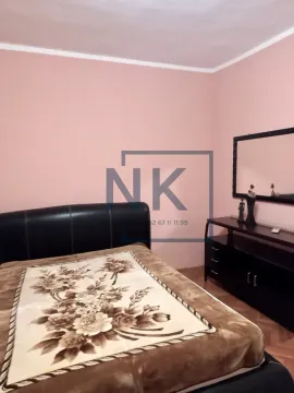 Bedroom with a double bed and dark furniture with a mirror. - image 7