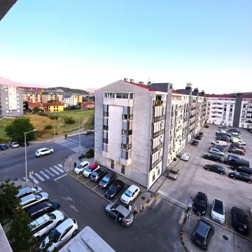 View from the terrace overlooking the building and surrounding parking. - image 8