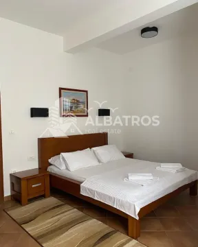 Bedroom with a double bed, wooden nightstands, and a painting on the wall. - image 6