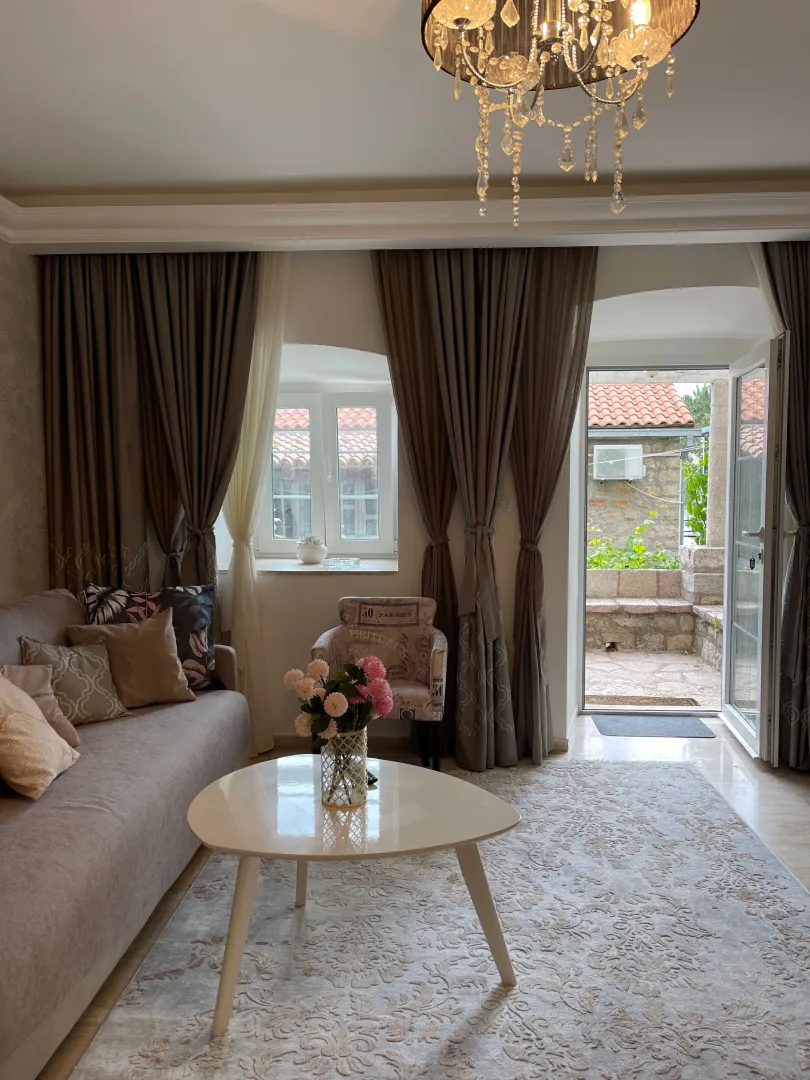 Decorated living room with a sofa, coffee table, and access to the terrace.