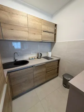 Modern kitchen with wooden cabinets and a built-in sink. - image 2