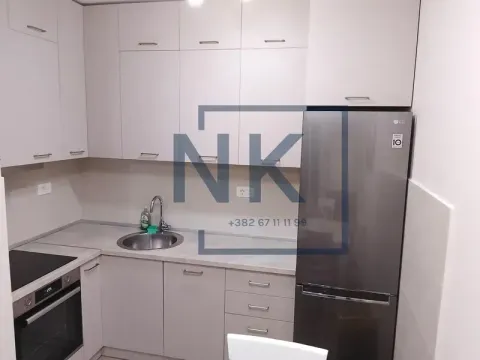 Small kitchen with white cabinets and a refrigerator. - image 5